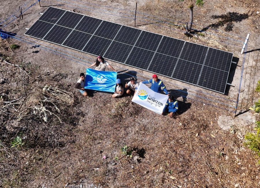 Petugas dan relawan berfoto di depan panel surya PLTS Off-Grid yang memasok listrik Pos Ranger Pulau Menjangan selama 24 jam. (foto/angga)