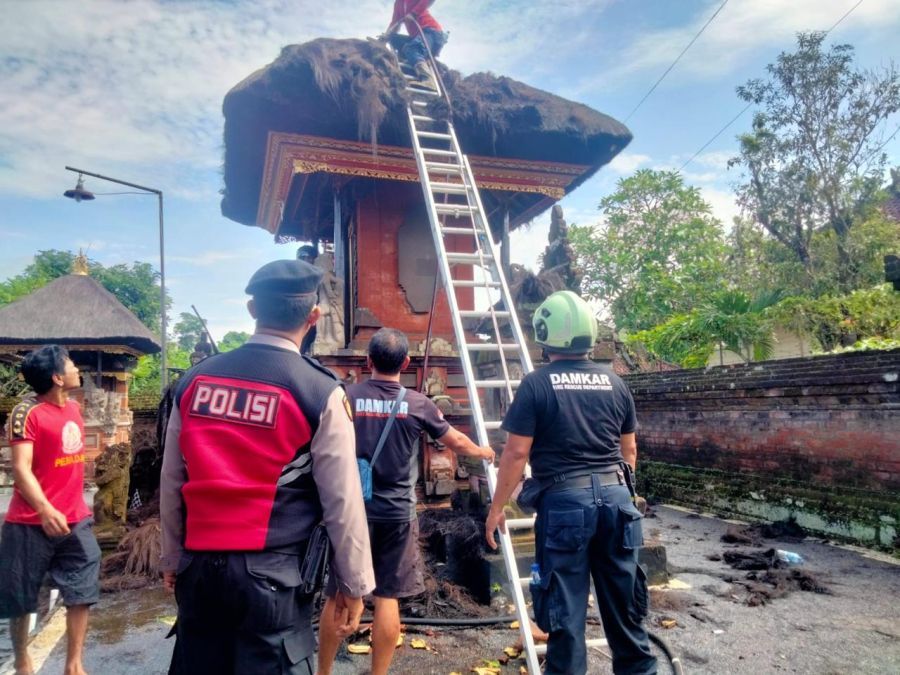 Petugas pemadam kebakaran memadamkan api di pelinggih Gedong Kawitan Pura Karang Buncing, Desa Sibangkaja, Abiansemal. (foto/hes)