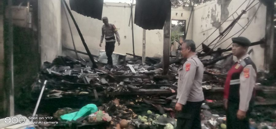 Polisi menjaga bekas warung sembako yang ludes terbakar, di Banjar Trijata, Desa Mambal, Kecamatan Abiansemal, Badung, Bali, ludes terbakar, Minggu (6/9/2026). (foto/hes)