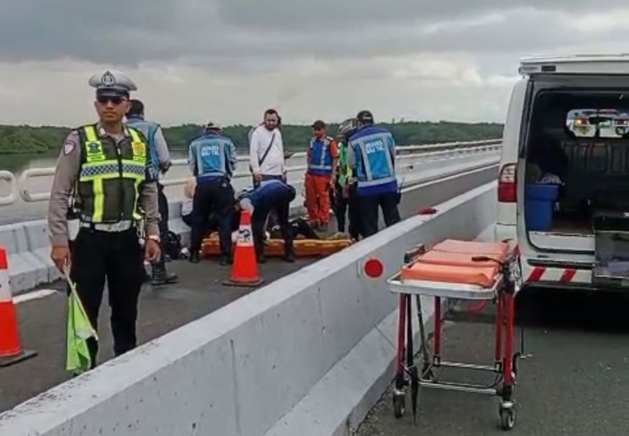 Petugas mengevakuasi turis asal Uzbekistan, berinisial TS yang mengalami kecelakaan saat mengendarai sepeda motor di Jalan Tol Bali Mandara, Rabu (3/12/2025). (foto/hes)